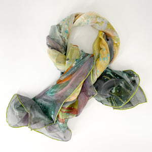 A silk scarf laid out in a knot shape, with lilac, yellow and grey colours from the Three Graces design.