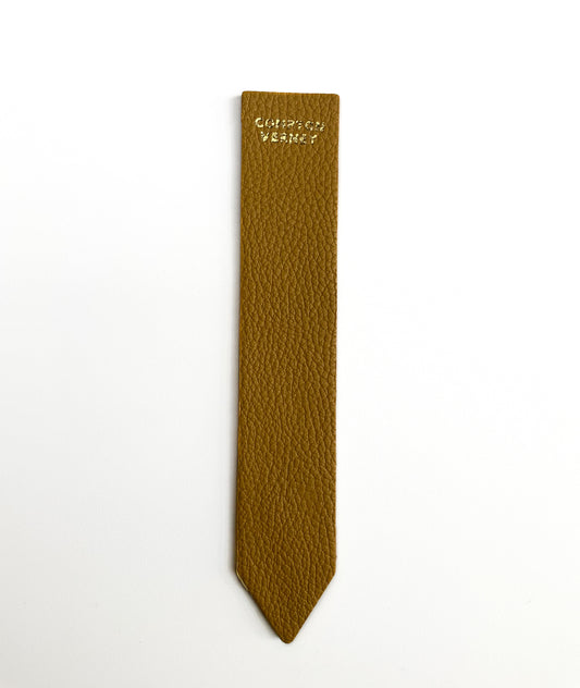 Handmade mustard leather bookmarks embossed with the Compton Verney Motive.